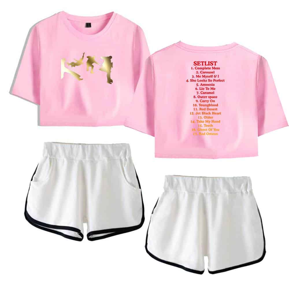 Bathtub silhouette gold print, pink cropped t-shirt with setlist on back, white athletic shorts with black trim, casual sportswear combination, modern streetwear style for women and teens.