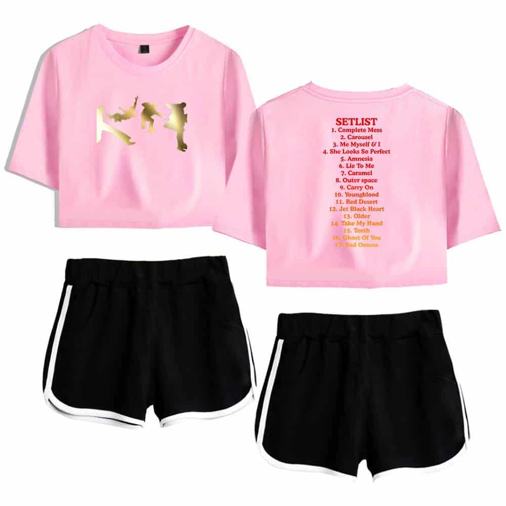 Pink casual crop top featuring a gold silhouette print of three dancers, paired with black athletic shorts with white trim. The set offers a fun and sporty look perfect for casual outings or dance classes.