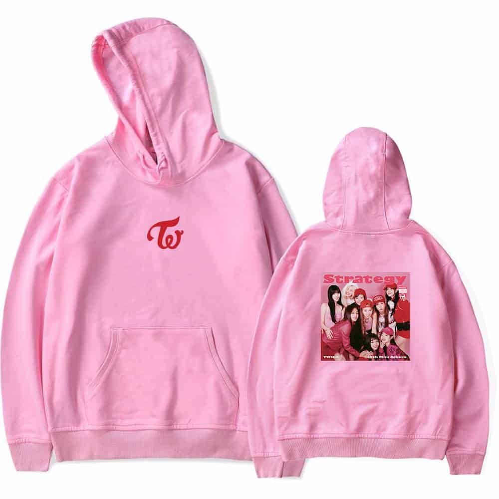 Twice merchandise pink hoodie with group image and strategy text on back, casual streetwear, popular K-pop girl group fans apparel, comfy and stylish unisex hoodie for fans, vibrant pink color with logo and photo print.