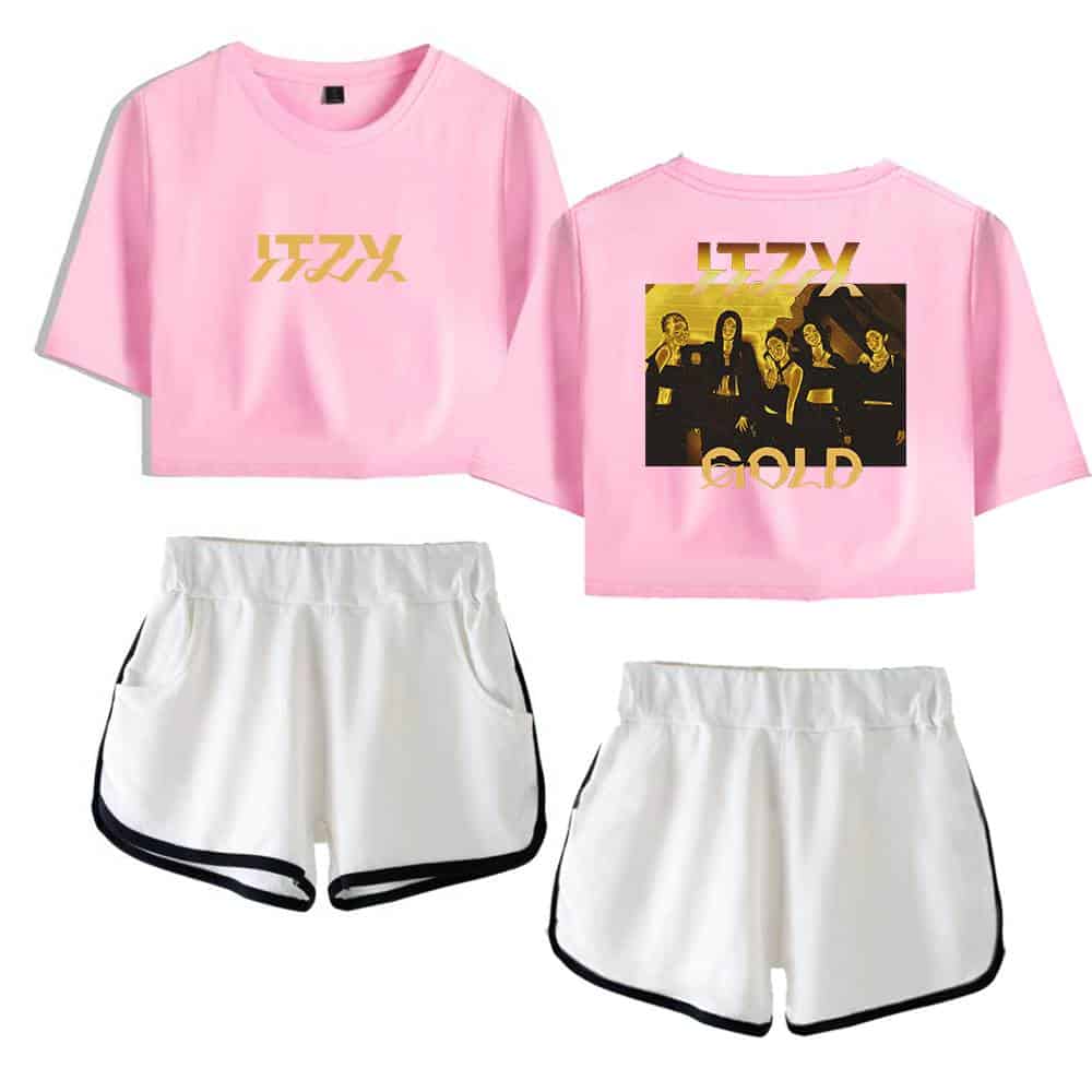 Pink cropped t-shirt with gold text and a graphic of a band on the back paired with white athletic shorts with black trim.